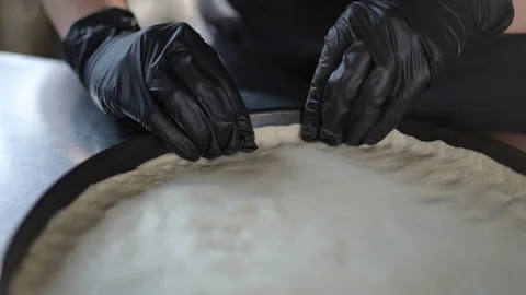 The skilled chef is meticulously preparing pizza  Stock Footage 296636580