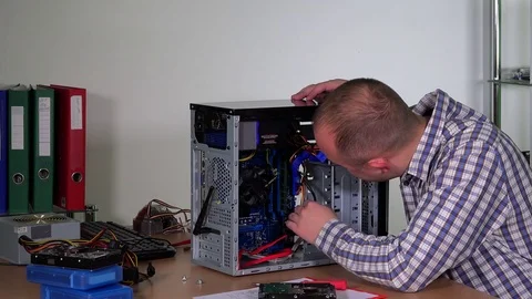 Skilled computer service worker man remove and examine ram memory plate Stock Footage 83031242