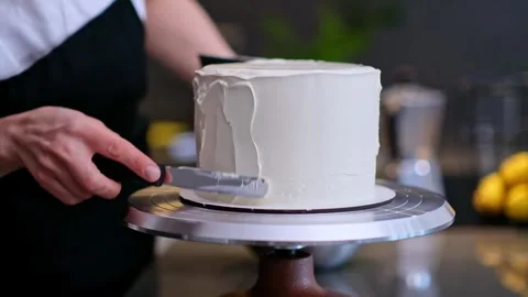 Skilled confectioner making pattern on white mastic with knife on blurred Stock Footage 250639338