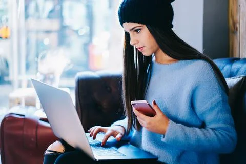 Skilled copywriter with cellphone checking content text for publish Stock Photos