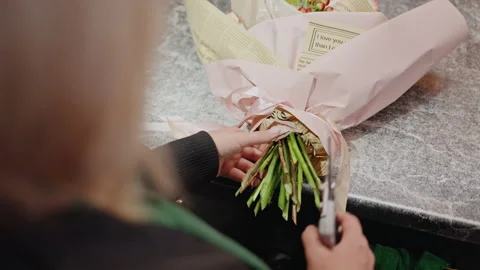 Skilled craftsperson precisely assembles stunning flower display. An experienced Stock Footage 331455000