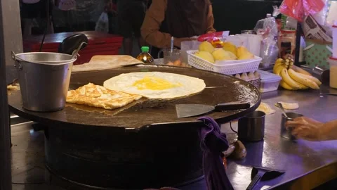 Skilled culinarian pours egg mixture onto stretched dough Stock Footage 285385127