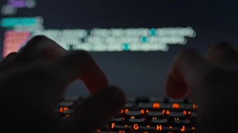 A skilled developer swiftly types intricate code on the keyboard refining a Vídeos de archivo 331456156