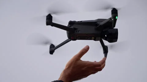 Skilled drone pilot launching, catching quadcopter with precision, highlighting Video stock 297612833