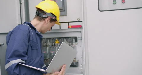 Skilled electrical engineer performs system diagnostics Stock Footage 336907213