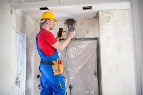 Skilled electrician using unimer Foto stock
