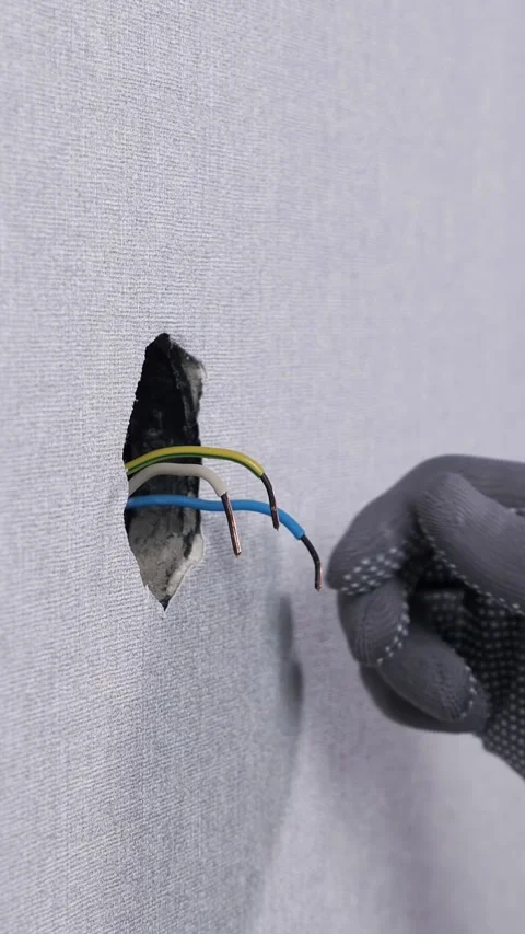 Skilled electrician's hands in protective gloves meticulously preparing and Видео 342908785