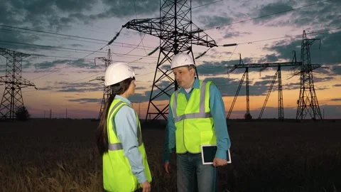 Skilled engineer with tablet shakes hand of woman assistant at energy Stock Footage 278010699