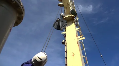 Skilled engineer in uniform lifts black ship radar to tower Stock Footage 113455145