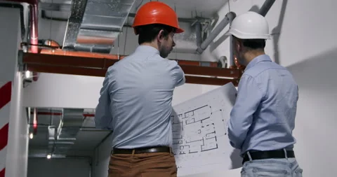 Skilled engineers discuss construction looking at drawings Vídeos de archivo 247401507