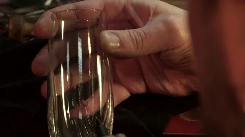 Skilled engraver meticulously crafting a pattern on glass Stock Footage 311946718