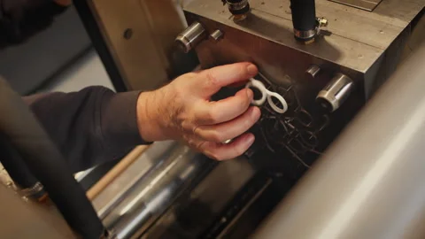 Skilled factory worker maintains plastic injection machine Stock Footage 313650803