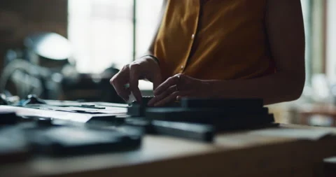 Skilled female print-maker placing wooden typography pieces for printmaking in i Stock Footage 199461986