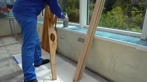 Skilled foreman man polish oak furniture boards with paint brush. Worker man Stock Footage 132470132