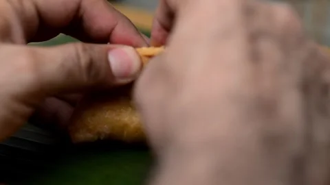 Skilled hands expertly cutting a delectable Salvadoran pastelito, revealing.. Stock-Footage 252339629