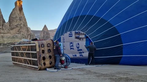 Skilled hands meticulously prepare a hot air balloon for takeoff. Stock Footage 263240064