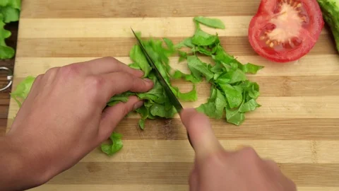 Skilled hands prepare vegetable salad cutting green lettuce Stock Footage 115154717