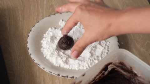 A skilled hands preparing cracked marble biscuits with care and precision Stockbeeldmateriaal 293099100