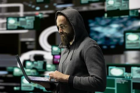 Skilled IT expert compromising cyber security through malware and viruses Stock Photos