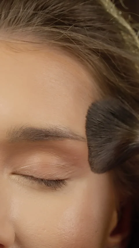 Skilled makeup professional carefully applying vibrant eyeshadow on models lid Stock Footage 304338143