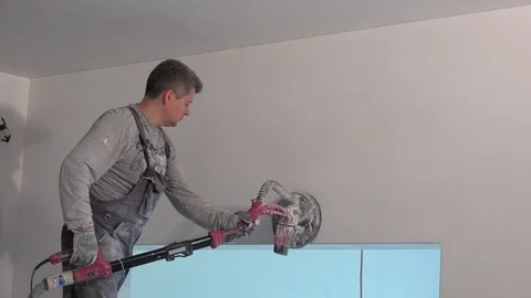 Skilled man with grinder machine polishing wall at new apartment Stock Footage 122312775