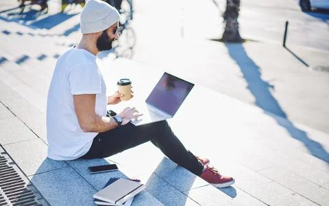 Skilled man making online booking and banking via application on modern laptop Stock Photos