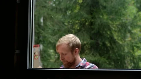 Skilled man measures window frame with level tool Video stock 322124031