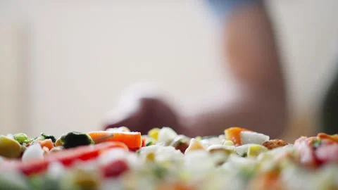 A Skilled Man Preparing a Delicious Pizza with a Variety of Colorful Ingredients Stock Footage 317780288