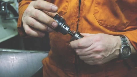Skilled master hands hold and repair important detail Stock Footage 133036639