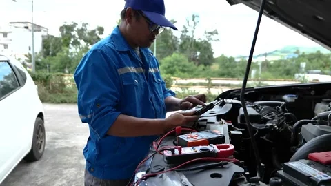 A skilled mechanic checks the car engine during a scheduled service appointment, Stock Footage 328639864