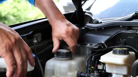 A skilled mechanic conducts an engine inspection in an auto service center, Stock Footage 327183308