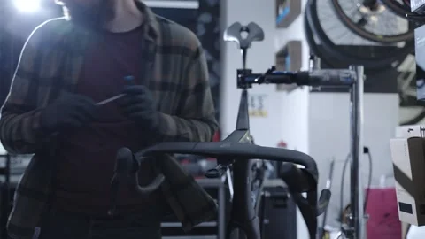 Skilled mechanic performs detailed service on a high end carbon road bike Stockbeeldmateriaal 336381238