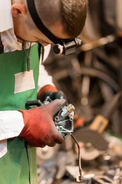 Skilled Mechanic Repairing Engine Component in Workshop Stock Photos