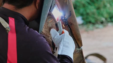 Skilled metalworkers work in the home workshop with an arc welding machine. Stock Footage 185394754