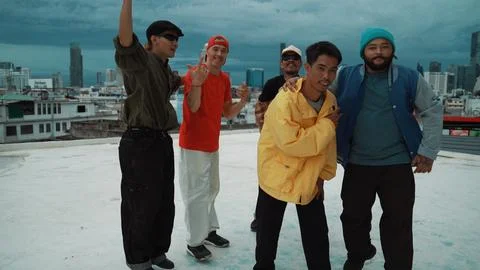 Skilled multicultural street dancing group pose at camera at roof top. Endeavor. 写真素材