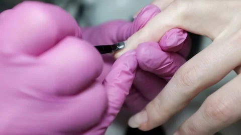 Skilled nail technician applying nail polish or base coat, making a manicure. Stock Footage 326251908