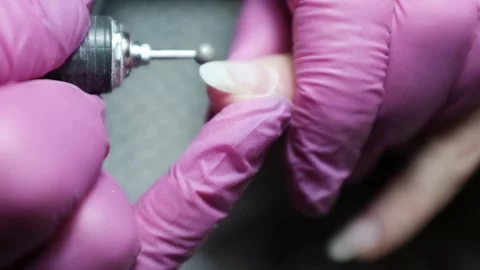 Skilled nail technician using electric manicure drill to remove gel coating Stock Footage 326251689