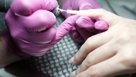 Skilled nail technician using electric manicure drill to remove gel coating Stock Footage 326252190
