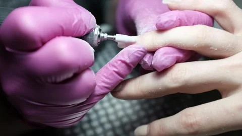Skilled nail technician using electric manicure drill to remove gel coating Stock Footage 326252194