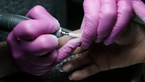 Skilled nail technician using electric manicure drill to remove gel coating Stock Footage 326252482