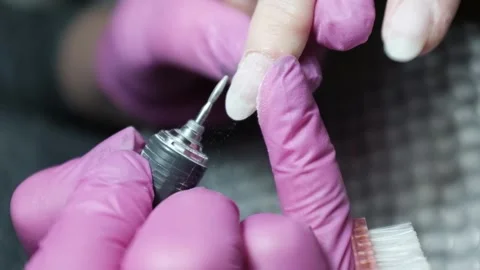 Skilled nail technician wearing rubber gloves removing cuticle with cutters Stock Footage 326251653