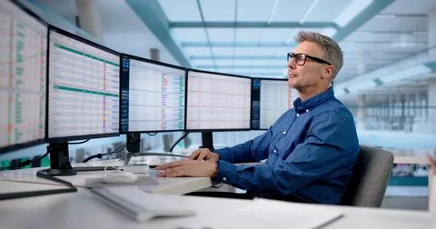 Skilled Office Manager Analyzing Data Across Multiple Business Monitors Stock Photos