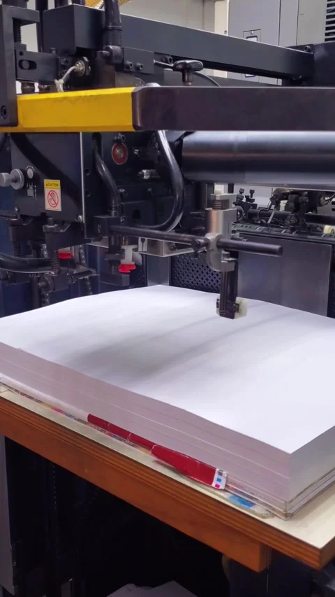 Skilled Operator Preparing High-Quality Paper Stack for Industrial Offset Press Stock Footage 337655698
