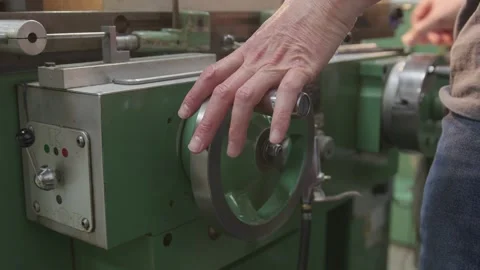 Skilled Operator's hands using controls of milling machine with confidence Stock Footage 136799935