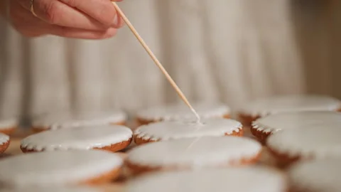 Skilled pastry chef designs consistent icing patterns. Creative baker Stock Footage 346389104
