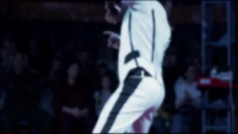 Skilled performer in white and black costume performing intricate hat and ball Stock Footage 342231049