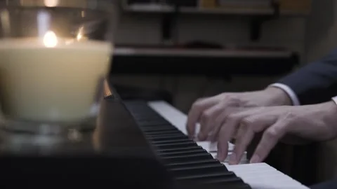 A skilled pianist effortlessly creates beautiful melodies on a digital keyboard. Stock-Footage 258946418