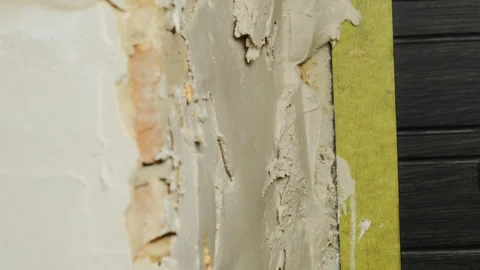 Skilled plasterer adds plaster on wall ensuring smooth surface Stock-Footage 304410037