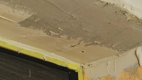 Skilled plasterer applies putty on wall ensuring surface smoothness Stock Footage 304414811