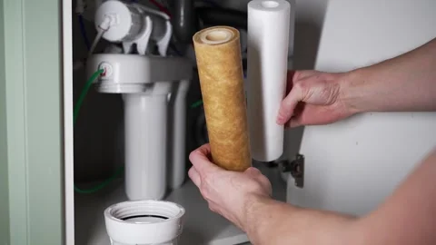 Skilled plumber replacing a corroded reverse osmosis water filter cartridge Stock Footage 326484641